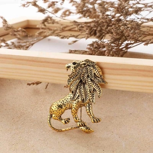 Macro shot of detailed lion brooch in vintage gold matte finish and engraved texture