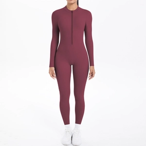 Detail of burgundy long sleeve yoga jumpsuit featuring a half-zip neckline and slim fit