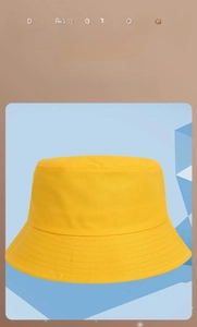 Detailed view of yellow cotton bucket hat with circular reinforced stitching on brim