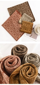 Close-up of four colored paisley print scarves with elegant silk texture and styling props