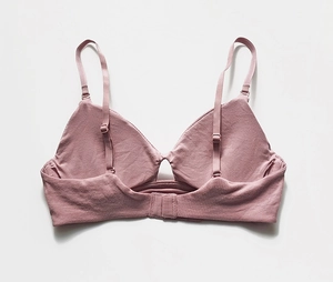 Detail view of the seamless back and ribbed strap structure of a mauve wireless bra