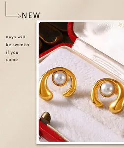 Detail of elegant gold-tone pearl earrings in a luxury jewelry gift box showcase