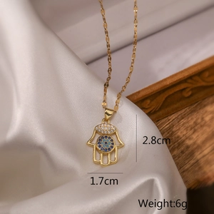 Detail of gold Fatima hand pendant with blue stones and measurements 2.8cm by 1.7cm