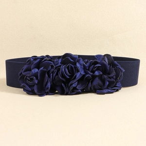 Detailed view of navy blue elastic waist belt featuring three fabric rose flowers