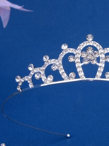 Detailed macro view of sparkling crystal rhinestones set in a silver tiara headband
