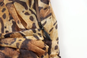 Macro detail of leopard print midi dress showing black invisible zipper and fabric texture