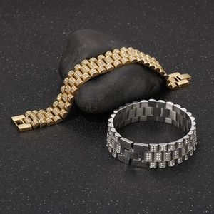 Macro detail of luxury hip hop tank bracelets in gold and silver with zircon pave setting