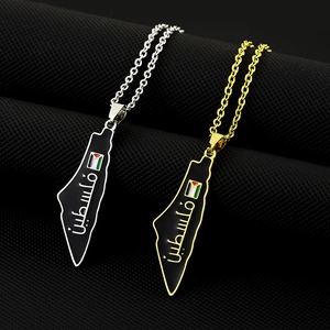 Macro detail of Palestine map pendants in gold and silver finish with black enamel