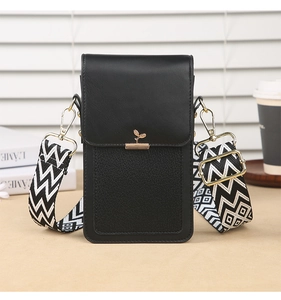 Detail of small black crossbody phone bag with gold leaf decor and pattern strap