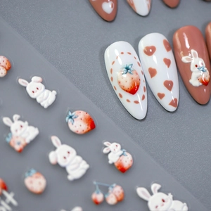 3D embossed nail stickers featuring cute rabbit and strawberry motifs in cream colors