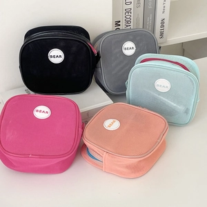 Detailed set of five colorful mesh storage bags with zipper and bear logo for travel