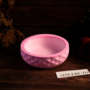 Detail of pink silicone bowl mold with geometric diamond pattern for candle making