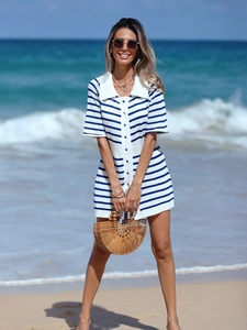 Detail of the blue and white striped knit texture and polo collar of the beach dress
