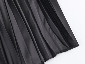 Detailed macro view of black pleated mesh fabric showing high-quality texture and stitching