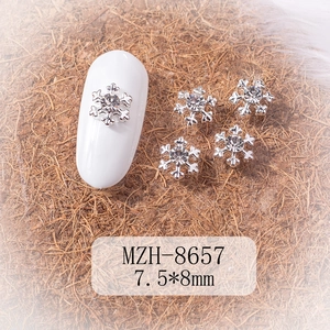 Detailed macro view of 7.5x8mm silver snowflake nail charm with center rhinestone
