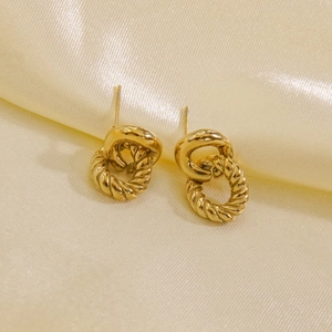 Detail of 14K gold plated stainless steel hoop earrings with twist rope and polished design