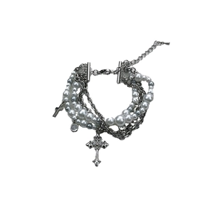 Bracelet multicouche Y2K en perles et chaîne avec pendentifs croix sur fond blanc neutre