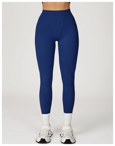 Detail of high waisted navy blue yoga leggings with V-shaped stitching and slim fit design