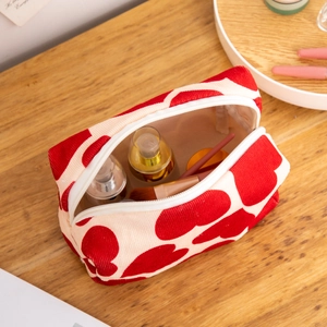 Octagonal beige corduroy makeup bag with red hearts and toiletry storage items