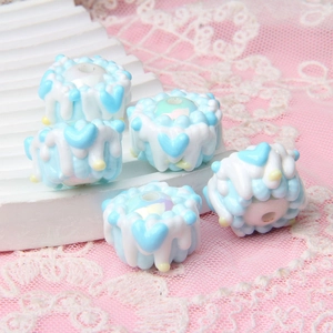 Detail of 5 blue and white layered cake charms made of acrylic for DIY bead crafting