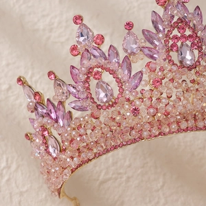Macro detail of handmade pink crystals and golden metal base on a bridal crown