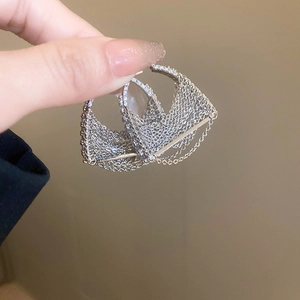Macro detail of silver layered fringe tassels on fashion hoop earrings for women