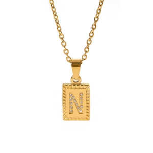Close-up of 18k gold plated rectangle pendant with crystal studded letter N on necklace