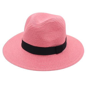 Detailed weave texture of pink Panama straw hat with a contrasting black ribbon band