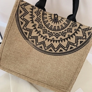 Close-up of ethnic geometric prints and woven texture on a linen tote bag