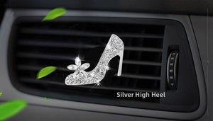 Detail of silver high heel car perfume clip with rhinestones and flower on air vent