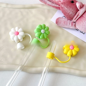 Detailed view of three colorful floral silicone straw covers on glass straws