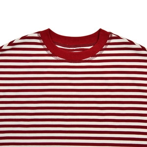 Detailed view of the ribbed crewneck and red striped pattern on a cotton knit top