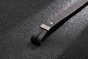Détails macro du bracelet en cuir tressé noir avec fermoir ancre en acier et coutures