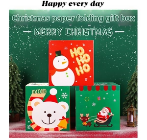 Three festive Christmas paper gift boxes with Santa and Snowman designs on green background