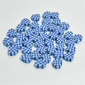 Macro shot of heart-shaped 10mm beads with blue checkerboard patterns for DIY jewelry