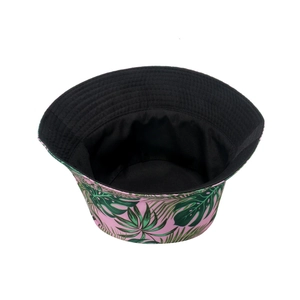 Detail of pink tropical bucket hat showing green palm leaf print and black inner lining