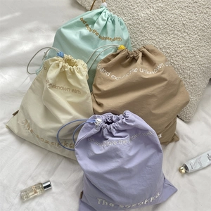 Set of four pastel drawstring organizers for cosmetics and travel essentials storage
