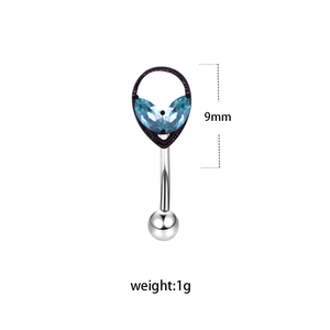 Detail view of silver eyebrow ring with blue marquise gems and black teardrop setting