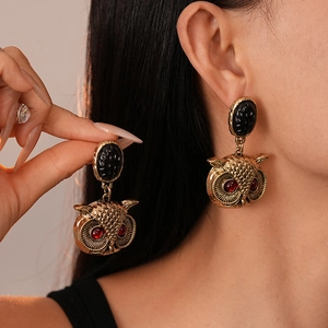 Vintage owl drop earrings in gold alloy with black gemstone and red crystal eyes