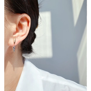 Two-tone gold and silver rivet stud earrings on model for a modern punk minimalist style