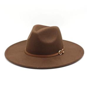 Detail of the brown wide brim fedora hat featuring a leather band and gold buckle accent