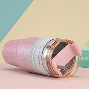 Detail of 30oz pink glitter vacuum insulated tumbler with clear lid and straw