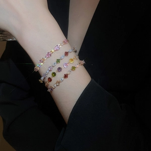 Close-up of sparkling colorful zircon tennis bracelets worn on a model's wrist