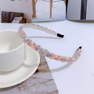 Detailed view of colorful beaded woven headband with pastel pearls and fabric ends