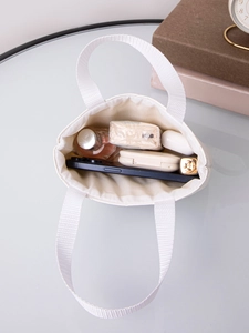 Top view of cream white quilted tote bag showing spacious interior with daily essentials