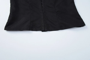 Close-up of hook-and-eye closure and stitched hem on black short sleeve cardigan