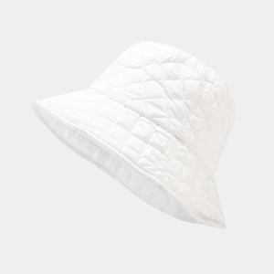 Detail view of white quilted bucket hat showing diamond stitching and warm puffy texture
