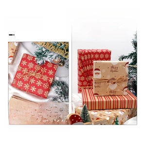 Detail of Christmas kraft wrapping paper with Santa, snowflakes and twine decoration