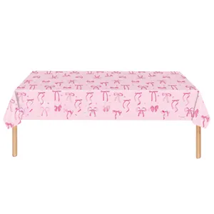 Pink rectangular party tablecloth featuring deep pink bow patterns and stars