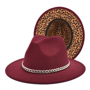 Detail of burgundy fedora hat with leopard print brim lining and silver chain trim